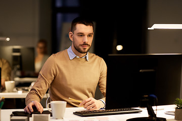 Image showing man with computer working late at night office