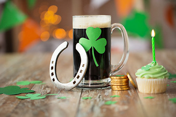 Image showing glass of beer, horseshoe, green cupcake and coins