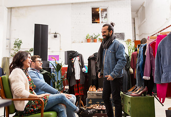 Image showing friends choosing clothes at vintage clothing store