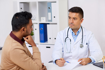 Image showing doctor showing prescription to patient at clinic