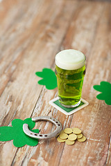 Image showing glass of green beer, horseshoe and gold coins