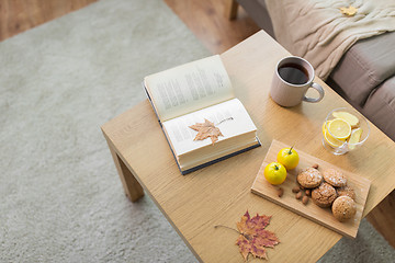 Image showing book, lemon, tea and cookies on table at home