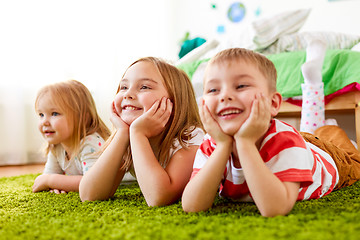 Image showing happy little kids lying on floor or carpet