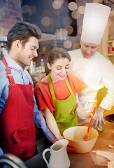Image showing happy couple and male chef cook cooking in kitchen
