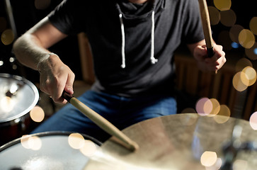 Image showing male musician playing drum kit at concert