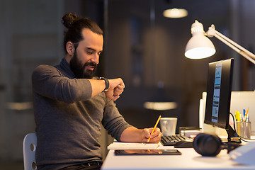 Image showing man with smartwatch using voice recorder at office