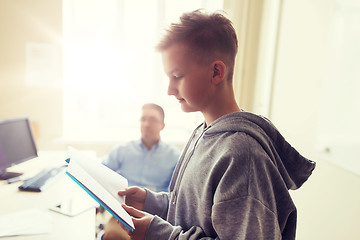 Image showing student boy with notebook and teacher at school