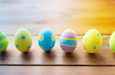 Image showing colored easter eggs on wooden surface