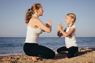 Image showing Happy family standing on the beach at the day time.