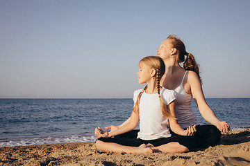 Image showing Happy family standing on the beach at the day time.