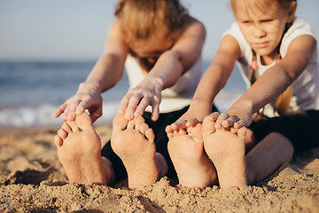 Image showing Happy family standing on the beach at the day time.