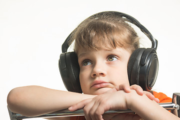Image showing Portrait of a girl in headphones listening to music musically
