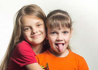 Image showing Portrait of two sisters having fun looking at the frame