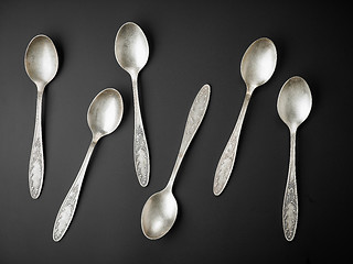 Image showing old silver spoons on black background