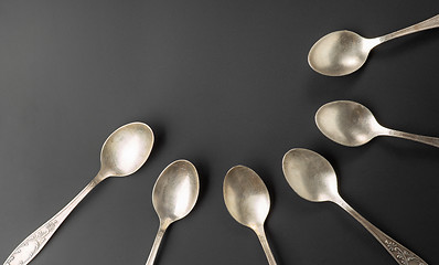 Image showing old silver spoons on black background