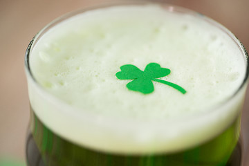 Image showing close up of glass of green beer with shamrock
