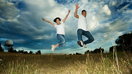 Image showing Asian couple jumping in joy