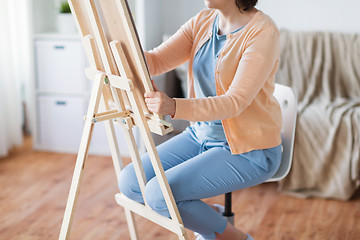 Image showing artist with easel drawing picture at art studio