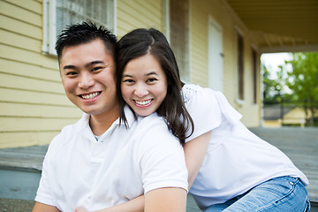 Image showing Asian couple in front of their house