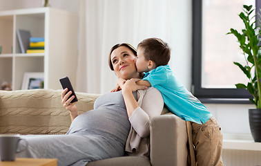 Image showing son kissing happy pregnant mother at home