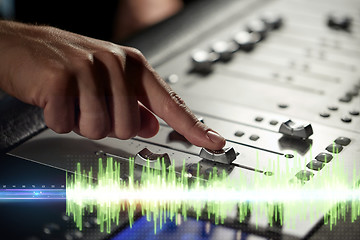 Image showing hands on mixing console in music recording studio