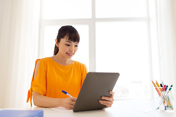 Image showing asian student girl with tablet pc learning at home