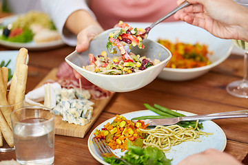 Image showing people eating salad at table with food