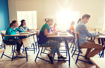 Image showing group of students with books writing school test