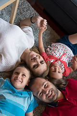 Image showing happy family lying on the floor