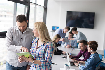 Image showing Two Business People Working With Tablet in office