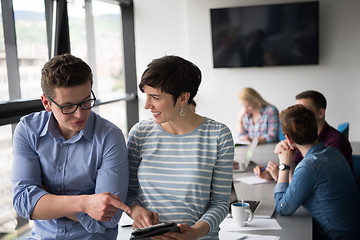 Image showing Two Business People Working With Tablet in office