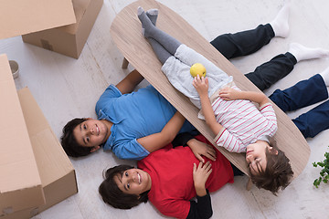 Image showing boys with cardboard boxes around them top view