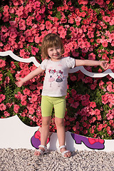Image showing little cute girl in a flower garden