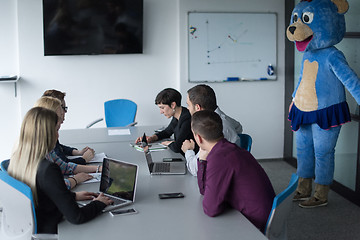 Image showing boss dresed as bear having fun with business people in trendy of