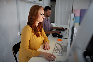 Image showing happy woman with computer working at office