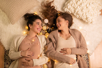 Image showing happy female friends in pajamas at home