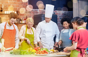 Image showing happy friends and chef cook cooking in kitchen