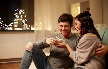 Image showing happy couple with gift box at home