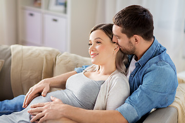 Image showing man hugging pregnant woman at home