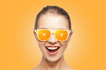 Image showing happy teenage girl in sunglasses with oranges