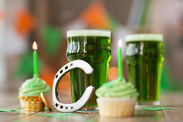 Image showing glass of beer, cupcakes, horseshoe and gold coins