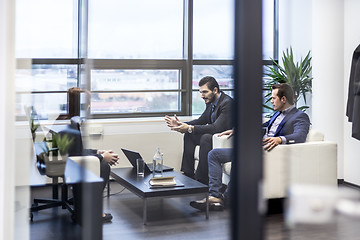 Image showing Business people sitting at working meeting in modern corporate office.