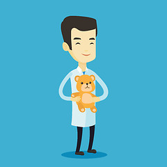 Image showing Pediatrician doctor holding teddy bear.