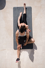 Image showing woman with personal trainer doing morning yoga exercises top vie