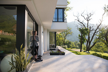 Image showing woman in front of her luxury home villa