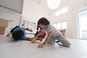 Image showing boys having fun with an apple on the floor