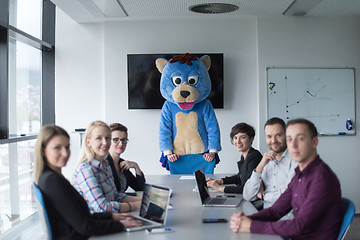 Image showing boss dresed as bear having fun with business people in trendy of