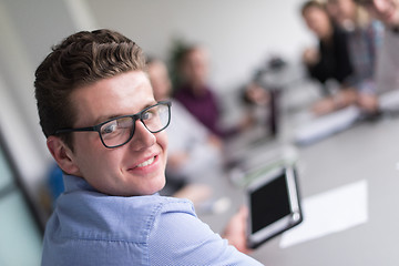 Image showing Businessman using tablet in modern office