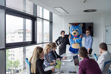 Image showing boss dresed as bear having fun with business people in trendy of