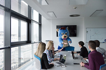 Image showing boss dresed as bear having fun with business people in trendy of